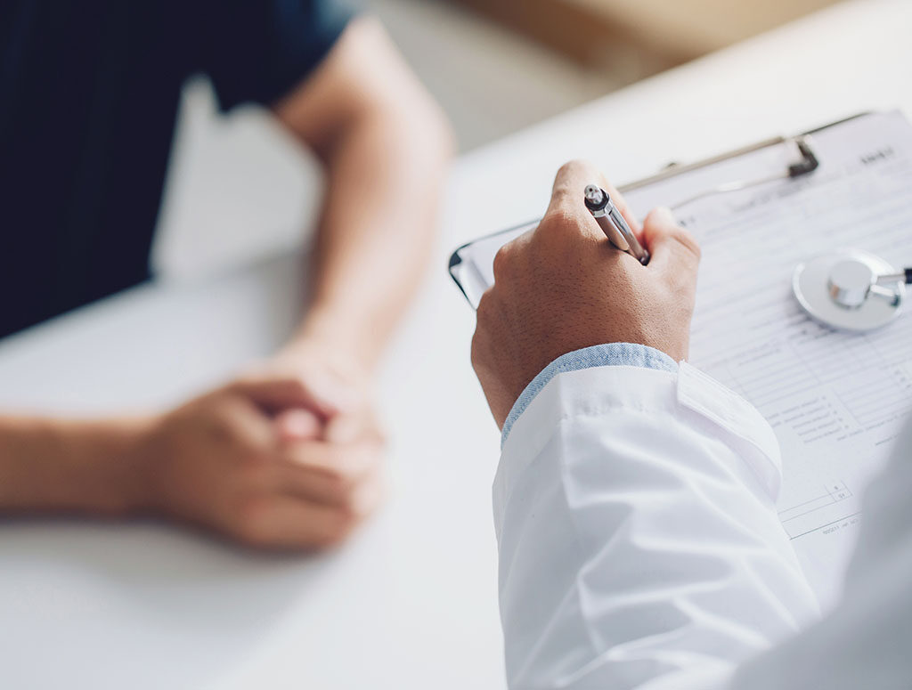 doctor holding test results and consulting patient at desk medic
